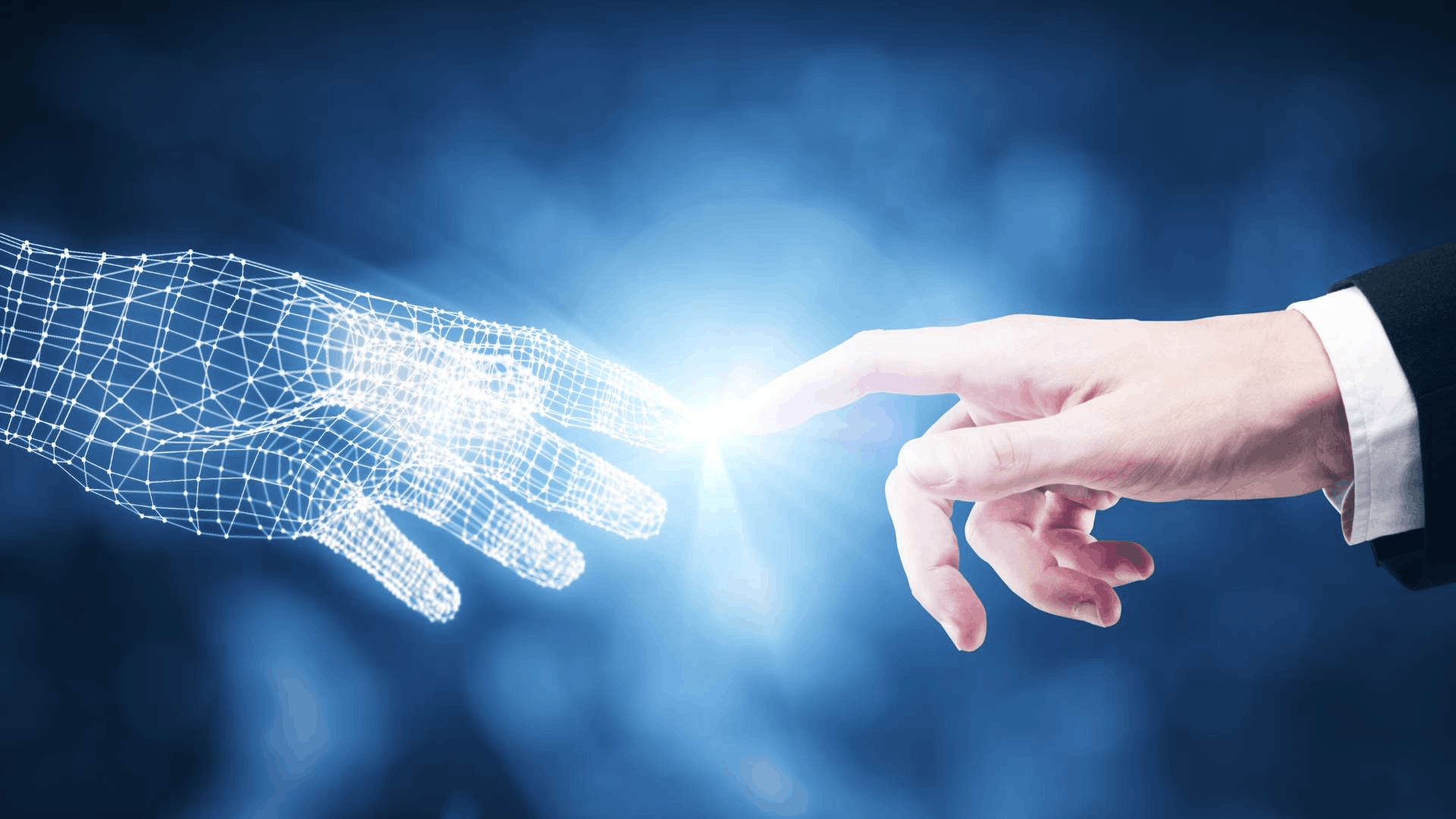 Human hand touching a digital robotic hand