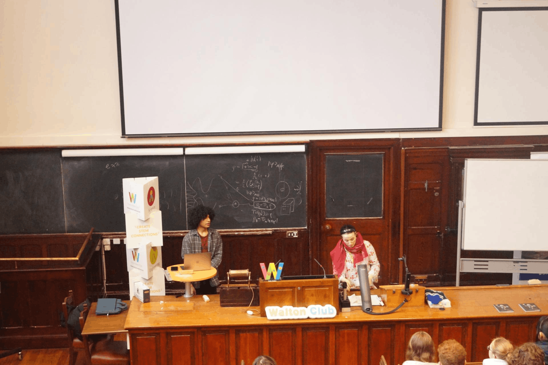 Trinity Walton Club presentation at the front of a lecture hall