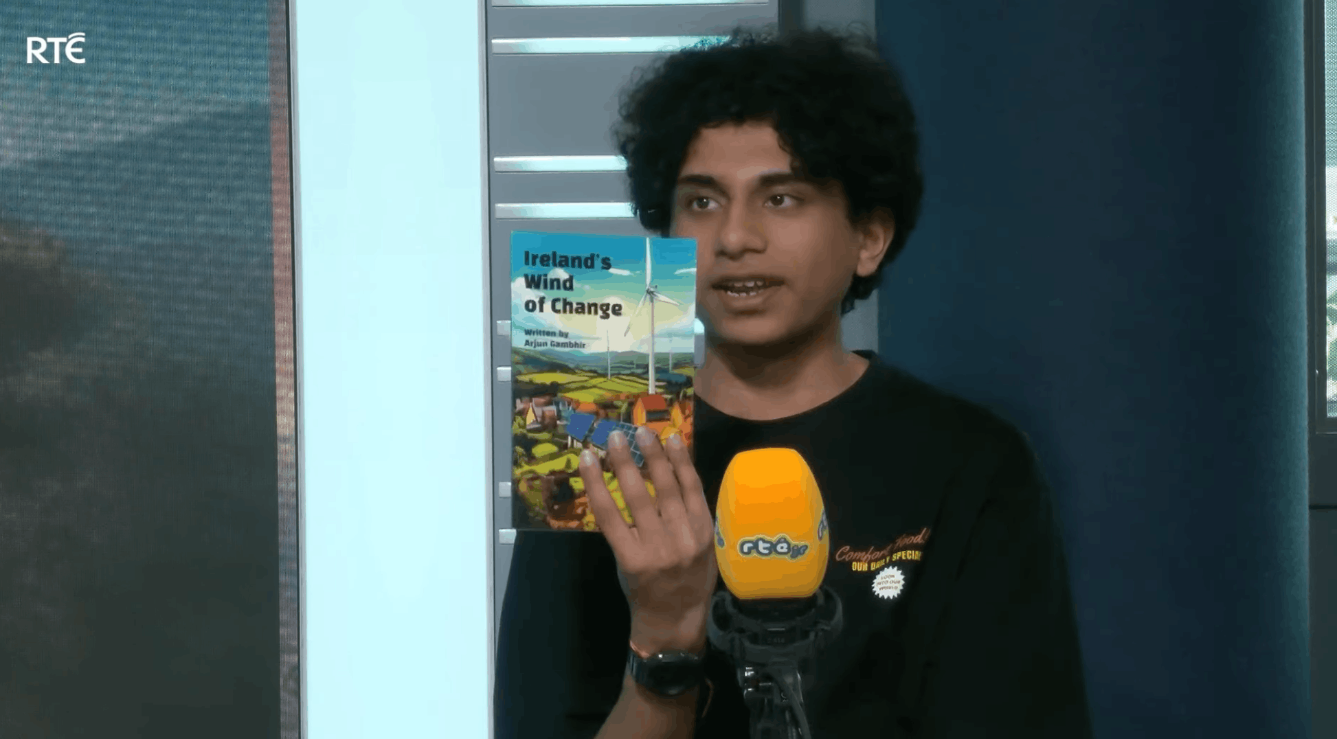 Arjun holding Ireland's Wind of Change during an RTÉjr interview