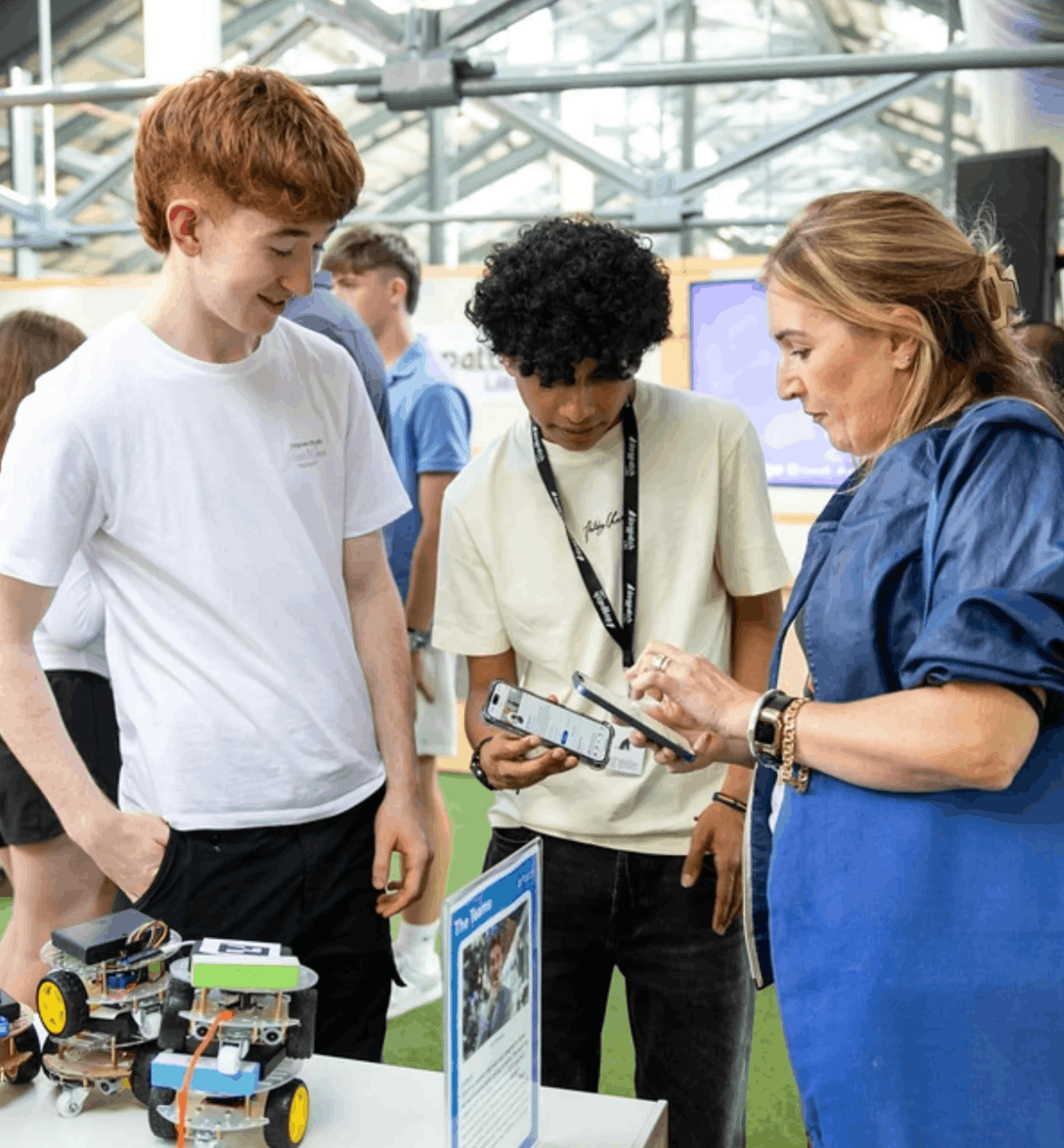Arjun and Shane demonstrating the Swarm Inc. robots to a visitor