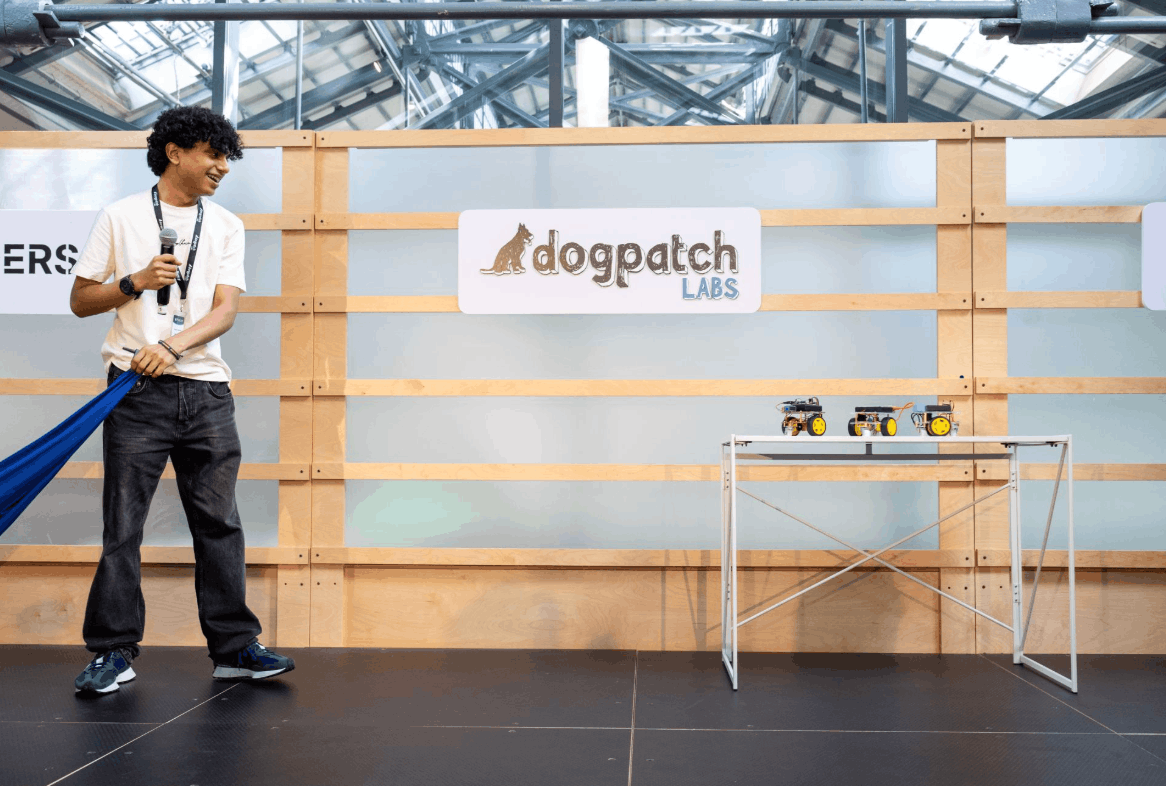 Arjun presenting three Swarm Inc. robots on stage at PATCH Demo Day